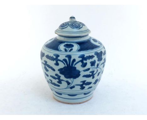 A Chinese blue and white porcelain covered jar, decorated with trailing lotus below panels of flowers, rabbit mark to base, l