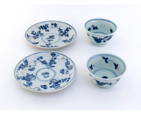 A pair of Chinese blue and white porcelain tea cups and saucers, floral pattern, Kangxi period, 17th century, 5cm high each s