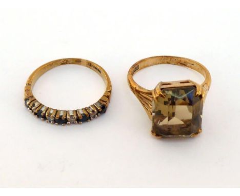 Two 9 carat gold and gem set rings, including one set with a citrine, finger size J, the other 9 stone half hoop ring set wit