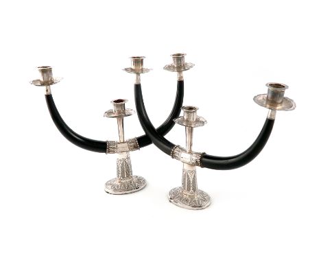 A pair of Malaysian metalware and horn two-light candelabra, marked with a signature, Malaysia and 1260B, with a central circ