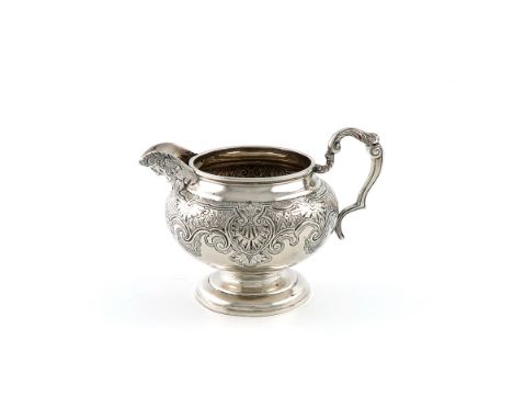 A George IV silver cream jug, by John Baddeley, London 1820, circular bellied form, foliate capped scroll handle, chased foli
