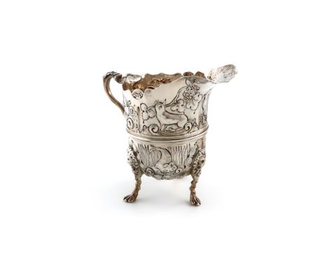 A late Victorian silver cream jug, by Nathan &amp; Hayes, Chester 1898, baluster form, embossed with birds and animals in a n