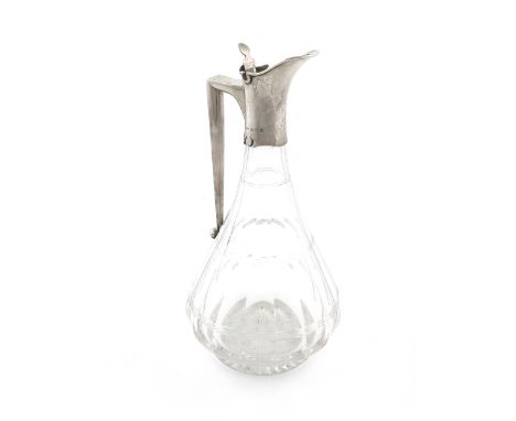 An Edwardian silver-mounted glass claret jug, by J. Grinsell, Birmingham 1904, tapering panelled circular form, the mount wit