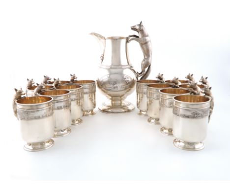 A silver hunting beer jug with a set of twelve beer mugs, by L.A Crichton, London 1930, the jug of baluster form, with a cast