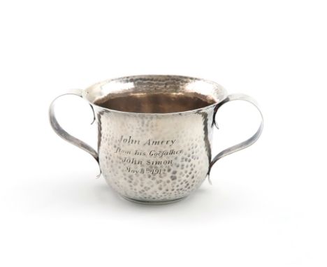 By Moss Morris, an Arts and Crafts presentation silver porringer, London 1905, circular form, scroll handles, spot-hammered d