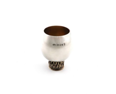 By Stuart Devlin, a modern parcel-gilt silver beaker, London 1977, tapering circular form, on a raised circular foot with pie