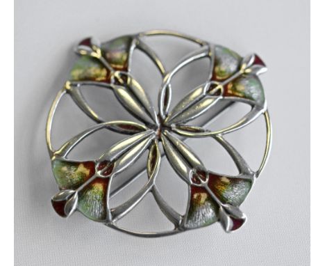 TWO ENAMELLED WHITE METAL BROOCHES, the first circular, pierced and enamelled as a stylised flowerhead, pin fastener to rever
