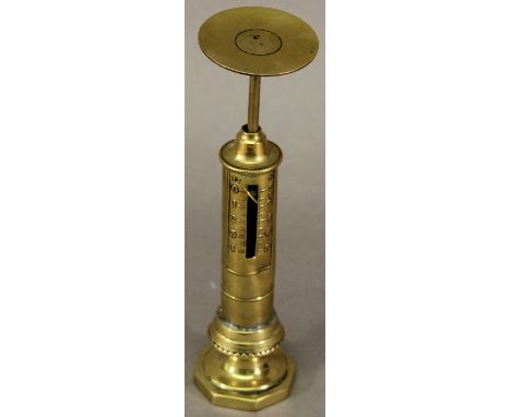 A PAIR OF LATE 19TH CENTURY BRASS PILLAR POSTAL SCALES with small circular tray, the cylindrical column with scale enclosing 