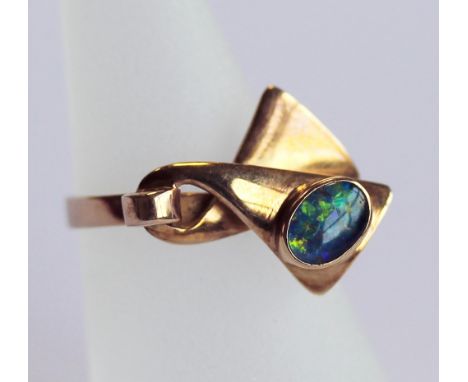 A 14CT GOLD AND OPAL RING, the oval opal cabochon set to a stylised ribbon platform, the shank marked 585, ring size L. 4gram