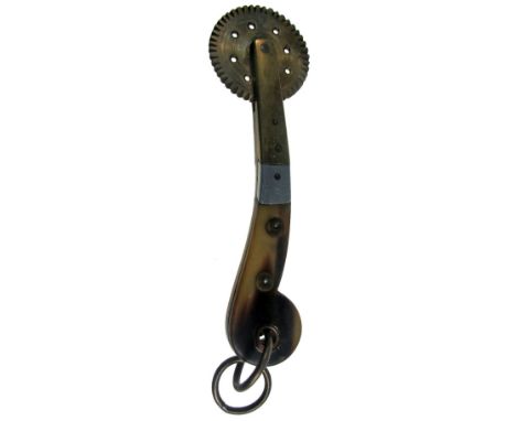 AN UNUSUAL PASTRY JIGGER with copper-alloy wheel mount and tang, the handle scales of oxhorn with aluminium ornament, with do