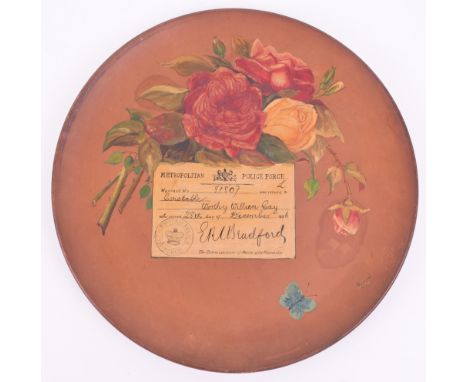 Watcombe Pottery Terracotta Plate of Metropolitan Police Interest, circular plate with painted floral scene and dedication pa