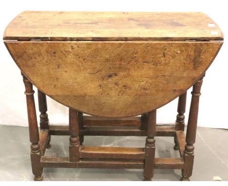 A late 18th Century oak farmhouse dropleaf table of small proportions raised on gate supports, 88 x 104 x 72 cm H. Not availa