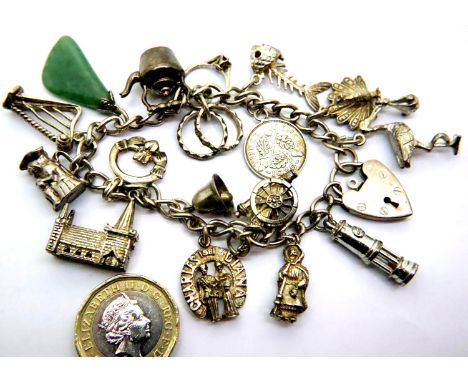 Silver charm bracelet with eight charms, 47g. P&amp;P Group 1 (£14+VAT for the first lot and £1+VAT for subsequent lots) 