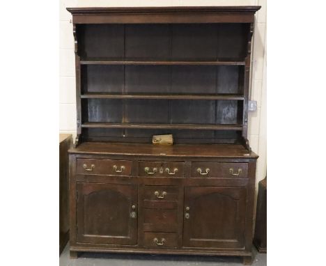 George II oak dresser, the three shelf plate rack raised on a base of cupboards and drawers, 140 x 48 x 191 cm H. Not availab