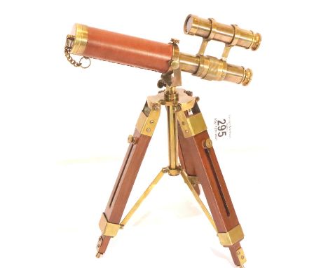 Brass and leather telescope on wooden tripod, H: 35 cm. P&amp;P Group 3 (£25+VAT for the first lot and £5+VAT for subsequent 