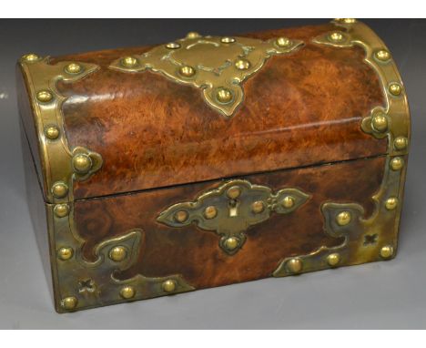 A Victorian walnut and brass mounted domed tea caddy, the cut card brass work with studs, the interior with two lidded compar