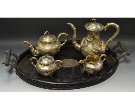 A good Chinese five piece silver and ebony tea and coffee service comprising of a  coffee pot, teapot, milk jug, two handled 