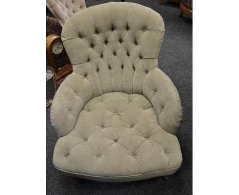 An early 20th century button back Lady's Fireside chair upholstered in mushroom coloured velvet , turned supports 