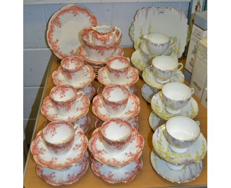 A Staffordshire part tea service printed in terracotta with flowers, gilt edged; a Foley china part tea service comprising of