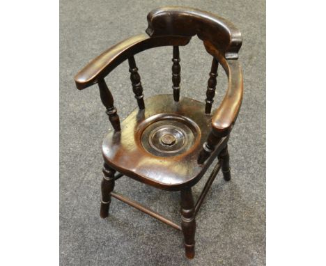 An early 20th century child's commode chair, turned legs and spindles