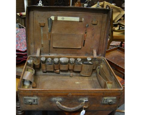 A 19th century leather rectangular travelling vanity case, the interior fitted with clear facetted Asprey jars, with silver c