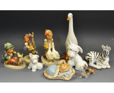 A Goebel figure, designed by MJ Hummel, Apple Tree Girl, printed marks;  others, Girl with two Geese;  Boy with flute and bir