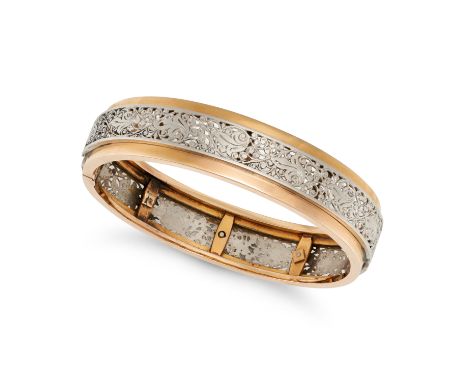 NO RESERVE - A VINTAGE FRENCH GOLD BANGLE in 18ct yellow and white gold, the hinged bangle comprising a central openwork whit