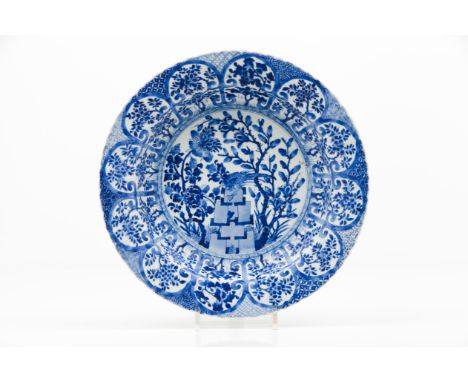 A large scalloped plateExport porcelainBlue and white decoration depicting landscape with birds, woods, rocks and flowersChin