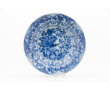 A large scalloped plateExport porcelainBlue and white decoration depicting landscape with birds, woods, rocks and flowersChin