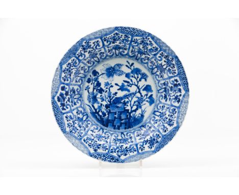 A large scalloped plateExport porcelainBlue and white decoration depicting landscape with birds, woods, rocks and flowersChin