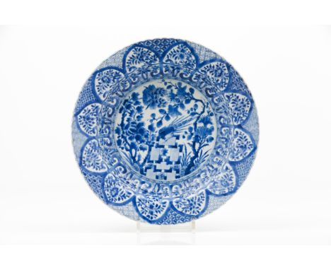A large scalloped plateExport porcelainBlue and white decoration depicting landscape with birds, woods, rocks and flowersChin