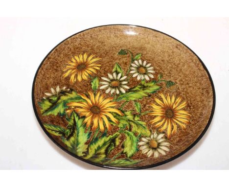 Linthorpe Pottery plate with sunflowers, artists monogram AB and Henry Tooth impressed, 29.5cm diameter.