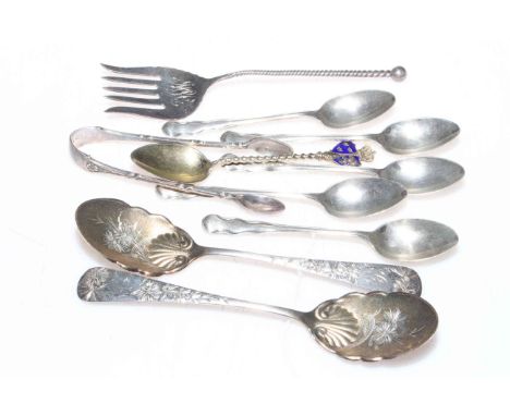 Sterling and hallmarked silver spoons, tongs, bread fork, and plated souvenir spoons.