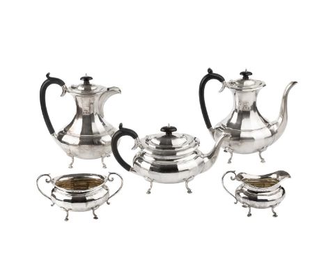 A George V silver five-piece tea and coffee service, of faceted oval baluster design, the tea and coffee pots with ebonised h