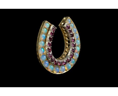 A Victorian ruby and opal horseshoe brooch, inset with rows of graduated cushion-shaped mixed-cut rubies and cabochon opals, 