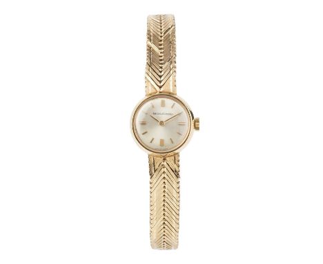 A lady's 9ct gold bracelet watch by Jaeger-LeCoultre, the circular silvered dial with gilt baton markers, to a jewelled manua