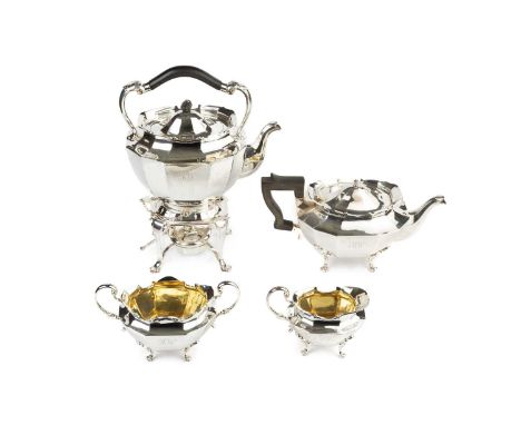 A George V silver four piece tea service, of oval faceted design, comprising tea kettle on stand with burner, teapot, twin ha