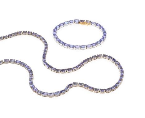 A collection of tanzanite jewellery, comprising a necklace and bracelet suite, each with a line of oval mixed-cut tanzanites 