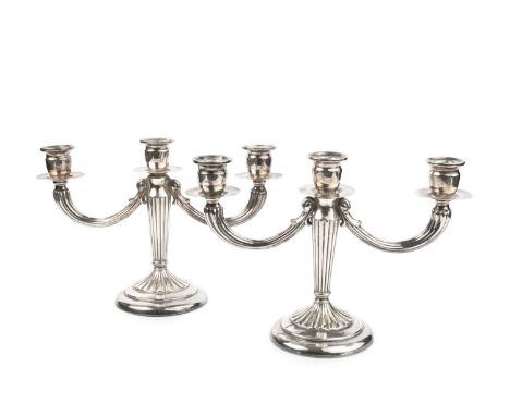 A pair of Peruvian silver three light candelabra, with lobed tapering columns, on circular weighted bases, stamped PERU 925 W