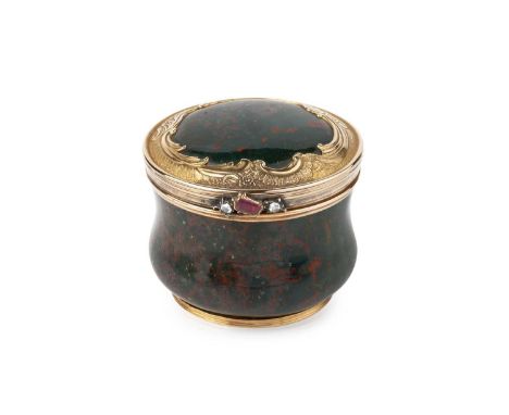 A Russian gold mounted bloodstone circular box, of rounded baluster form, the mounts to the hinged lid engraved with scrollin