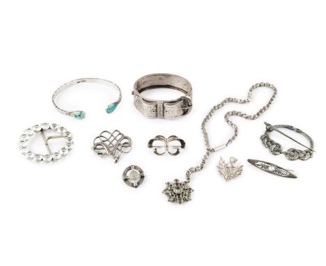 A collection of jewellery, comprising a white metal bangle, of hinged oval form, modelled as a belt buckle, with foliate scro