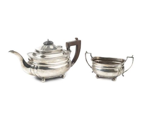 A George V silver teapot, and matching twin handled sucrier, with gadrooned borders, the teapot with wooden handle and knop, 