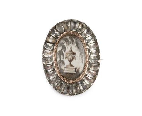 A late 18th/early 19th century ivory and paste memorial jewel, the oval ivory panel painted to depict a funerary urn and weep