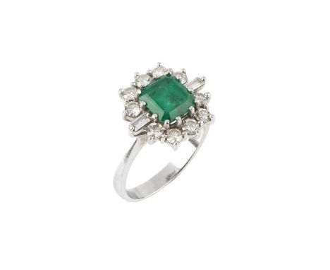 An emerald and diamond cluster ring, the rectangular step-cut emerald claw set within a border of round brilliant and baguett