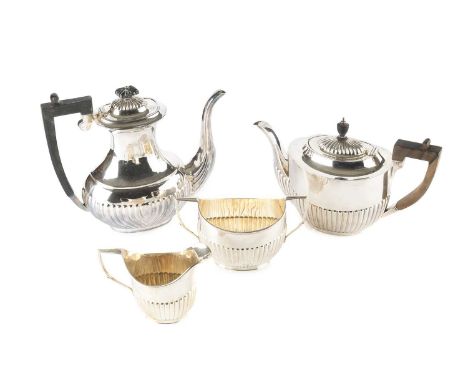 A George V silver three-piece tea service, of oval half-lobed form, the teapot with ebonised handle and knop, by Robert Pring