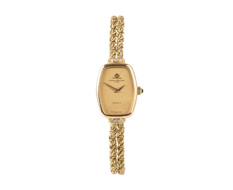 A lady’s diamond set bracelet watch by Baume &amp; Mercier, the tonneau-shaped gilt dial with tapered hands, to a double row 