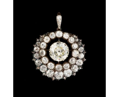 A diamond cluster pendant/brooch, centred with an old-cut diamond of yellow tint in pinched collet setting, within an openwor