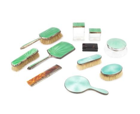 An Edwardian silver and turquoise enamel child's three piece dressing table set, comprising hand mirror, oval brush and cloth