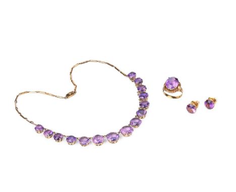 A matched suite of synthetic colour change sapphire jewellery, comprising a rivière necklace, ear studs and ring, set with ci