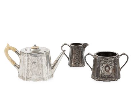 A Victorian three piece bachelor's tea service, of shaped oval tapered form, engraved with garlands of foliage, the teapot wi